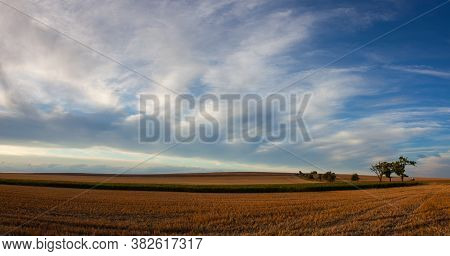 On The Empty Field After Harvesting In Summer Evening. Czech Republic. Amazing Sunset In Czech Bohem