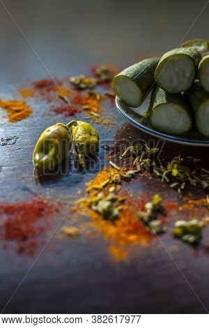 Close Up Shot Of Raw Galka Or Sponge Gourd Cut In A Glass Plate Along With All The Spices Including 