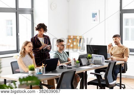 business, people and corporate concept - team of startuppers working at office