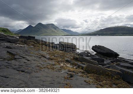 Coastal Landscape From The Isle Of Raasay Looking Towards The Isle Of Skye. Ferry Travels The Sea Un