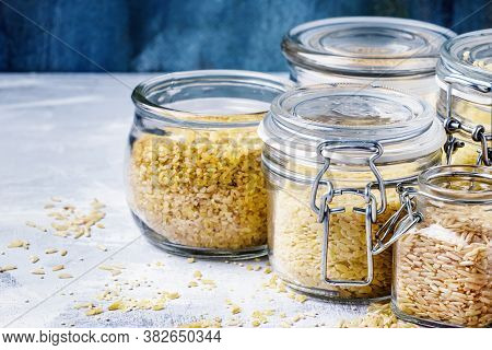 Assorted Cereals In Glass Jars: Kinoa, Bulgur, Couscous, Orzo, Brown Rice, Selective Focus