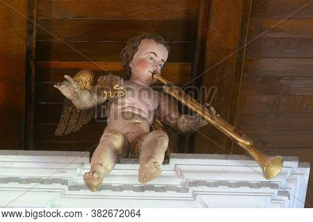 PETROVINA, CROATIA - JULY 22, 2013: Angel musician, statue on organ at Saint Peter Parish Church in Petrovina, Croatia