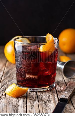 Boulevardier Cocktail And Orange Zest On Wooden Background