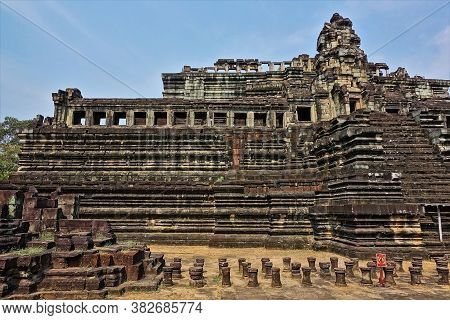 An Ancient Temple In The Form Of A Stepped Pyramid Against The Blue Sky, Decorated With Carvings, Or