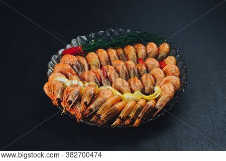 Shrimps With Lemon And Black Pepper On Dark Background
