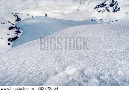 Frozen Glacial Lake Surrounded By Snow In A Cold Winter Landscape Seen From The Panticosa Ski Resort