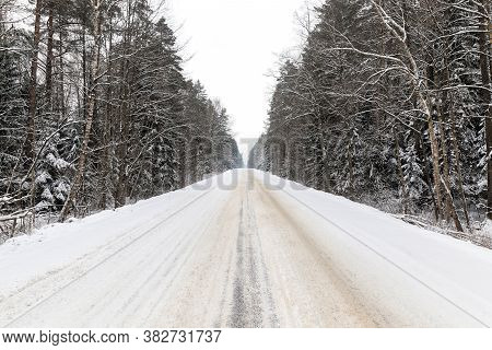 Tracks From The Tread Of A Car Tire In The Snow In The Winter Season, Tracks On The Site Of The Road