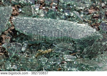 Broken Into Very Small Pieces Of Car Glass On The Asphalt After An Accident Committed With A Car, Th
