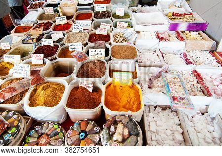 Heaps Of Colorful Spices On The Counter. Closeup Of A Counter With A Big Variety Of Spices On The An