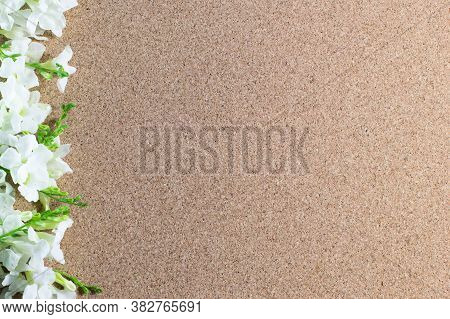 Frame Made Of White Flowers On A Brown Background, Flat Lay, Copy Space