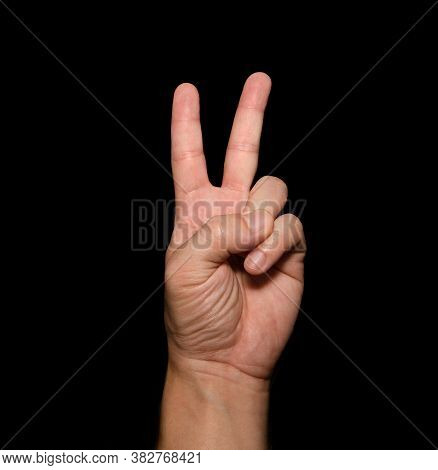 The Man's Hand That Holds Two Fingers Is A V Sign, Meaning Victory. Or Still Means Peace And Contemp
