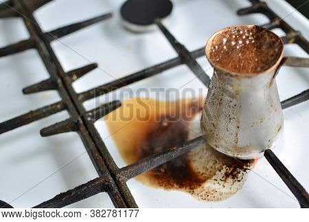 Spilled Cezve Of Coffee On Gas Stove