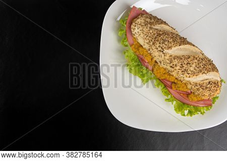 Mortadella And Lettuce Sandwich With Oregano-covered Bread, On A White Plate And Pepper Sauce And Mu