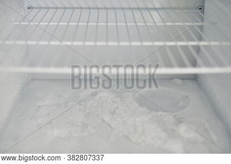 Ice Buildup In Freezer. Broken Frozen Refrigerator With Built Up Ice And Frost. Empty Freezer Drain 