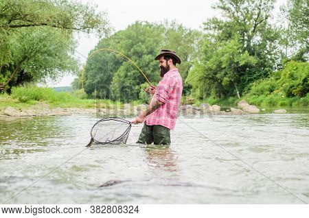Summer Weekend. Big Game Fishing. Bearded Fisher In Water. Hobby And Sport Activity. Pothunter. Matu