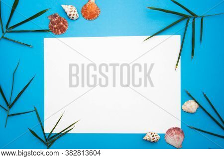 Blank Paper Concept For Text With Frames Adorned With Bamboo Leaves,shell And Blue Paper Background.