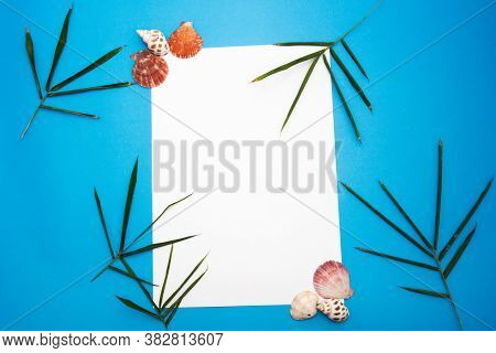 Blank Paper Concept For Text With Frames Adorned With Bamboo Leaves,shell And Blue Paper Background.