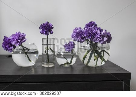 Bridal Bouquet Of Lilac Carnations In A Round Glass Vase