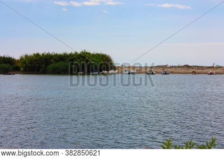 Glimpse Of Sea And River Among The Nature Of Marina Di Pisa In The Tuscan Serenity Of The Italian Su