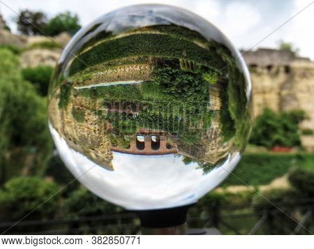Castle Bridge Made Of Red Bricks And Bock Casemates In Luxembourg, Seen Through Crystal Ball