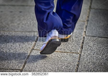 Closeup Of Japanese Monk In Traditional Sabo Walking On Street In Kyoto. Horizontal Image