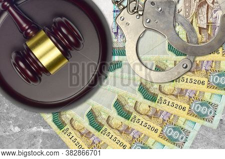 1000 Sri Lankan Rupees Bills And Judge Hammer With Police Handcuffs On Court Desk. Concept Of Judici