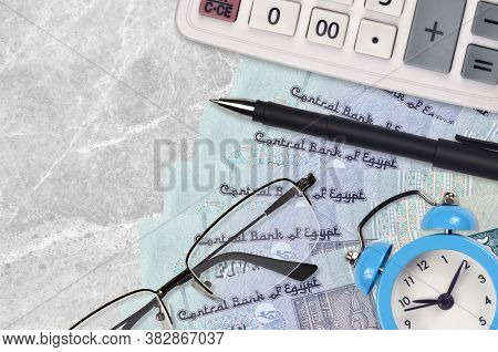 5 Egyptian Pounds Bills And Calculator With Glasses And Pen. Business Loan Or Tax Payment Season Con