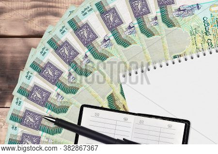1000 Sri Lankan Rupees Bills Fan And Notepad With Contact Book And Black Pen. Concept Of Financial P
