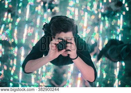 Photographer With Camera Reflecting In Mirrors Takes A Selfie In A Mirrored Entertainment Room