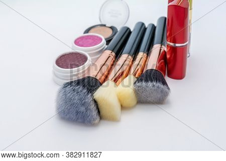 Cosmetic collection of makeup brushes and shadows