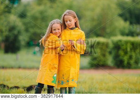 Adorable Little Girls Under The Rain On Warm Spring Day