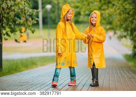 Adorable Little Girls Under The Rain On Warm Spring Day