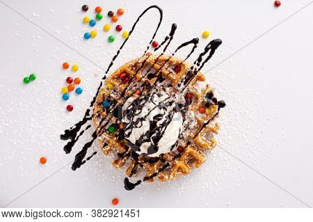 Belgian Waffle With A Scoop Of Ice Cream, Whipped Cream And Chocolate Syrup