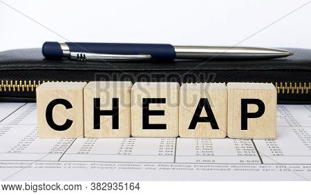A Word Cheap Written In A Wooden Cube With A Pen And Wallet