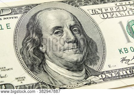 Macro view of Ben Franklin on the US one hundred dollar bill.
