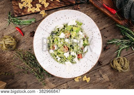 Italian Green Fettuccine Pasta With Tomatoes And Cheese On The Decorated Wooden Table