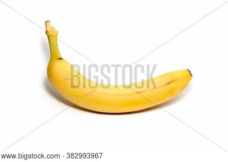 Single Banana Against White Background. Close Up