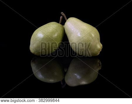 Green Ripe Pear On A Black Background. Bera Pear Variety, Large Fruits. Autumn Fruits.