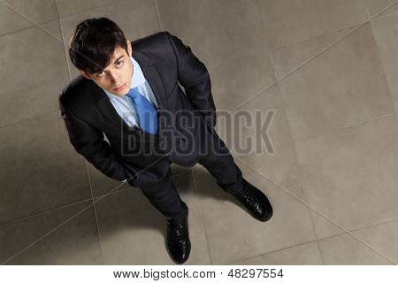 Young businessman looking above