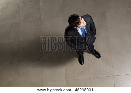 Young businessman looking above