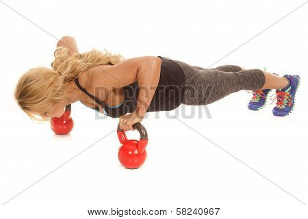 Mature Woman Doing Pushup On Kettle Bells