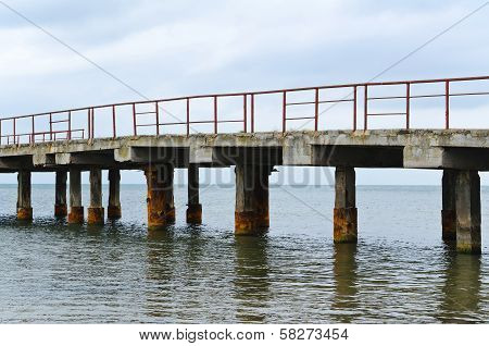 Deserted Old Bridge. Rusty And Unusable. Ferroconcrete Construction