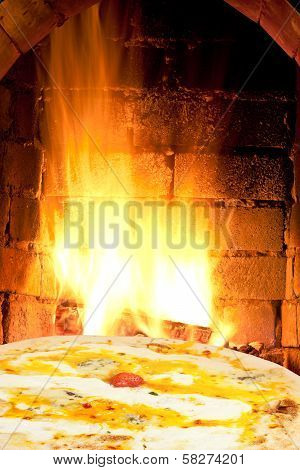Pizza Quatro Formaggi And Fire Flames In Oven