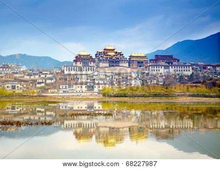 Landscape with tibetan monastery and lake