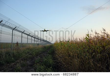 Fence Of Airport And A Plane