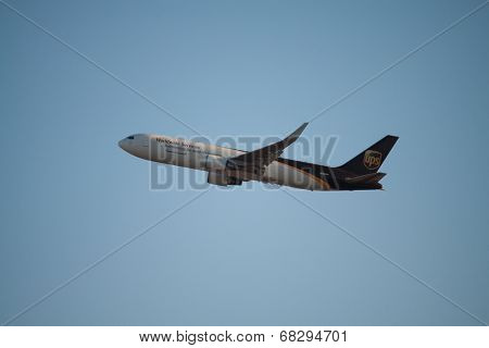 VALENCIA, SPAIN - JULY 10, 2014: An UPS aircraft departing the Valencia airport. UPS is one of largest package delivery companies worldwide with 397,100 employees and USD 54.1 billion revenue (2012).