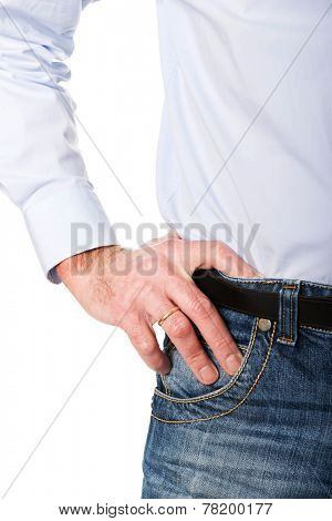 Close up man wearing jeans with hand on hip.