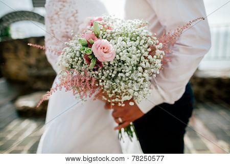 Wedding Bouquet In Groom's And Bride's Hands Closeup