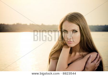 Woman In Dark Dress In The Beach