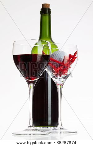 Wine Glasses With Red Wine And Golf Ball